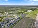 Extensive aerial view showing the layout of a community surrounded by lakes and forests at 12481 Aston Dr, Hudson, FL 34669