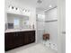 Bathroom featuring a double vanity and a glass-enclosed shower with stylish tiling at 12481 Aston Dr, Hudson, FL 34669