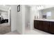Bathroom featuring a double vanity and access to the primary bedroom at 12481 Aston Dr, Hudson, FL 34669