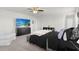 Spacious primary bedroom with a TV, ceiling fan, and a comfortable seating area at 12481 Aston Dr, Hudson, FL 34669