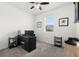 Neutral bedroom with a ceiling fan, desk, carpeted floor and lots of natural light at 12481 Aston Dr, Hudson, FL 34669