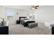 Bright bedroom featuring a ceiling fan, natural light, and a comfortable bed with bench at 12481 Aston Dr, Hudson, FL 34669