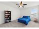 Bedroom with a blue bed and a bookcase at 12481 Aston Dr, Hudson, FL 34669