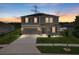 Charming two-story home featuring gray siding, green shutters, manicured lawn and a spacious driveway, perfect for families at 12481 Aston Dr, Hudson, FL 34669