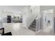 Inviting hallway with tile flooring, staircase, and a view into the spacious living area, creating a seamless transition at 12481 Aston Dr, Hudson, FL 34669