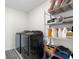 Laundry room equipped with a washer, dryer, and shelving for storage at 12481 Aston Dr, Hudson, FL 34669