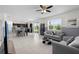 Open-concept living room featuring neutral decor, tile flooring, and ample natural light, perfect for relaxation and entertainment at 12481 Aston Dr, Hudson, FL 34669