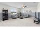 Bright and open living room with neutral tones, tile flooring, and comfortable seating arrangements, creates welcoming space at 12481 Aston Dr, Hudson, FL 34669