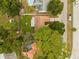 Aerial view of a home with a well-maintained backyard, pool, patio, and mature trees at 1349 Tyrone N Blvd, St Petersburg, FL 33710