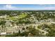 Areal shot showcasing neighborhood with lush green landscaping, a baseball field, and a pond at 1349 Tyrone N Blvd, St Petersburg, FL 33710