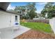 Spacious backyard with a well-maintained lawn, patio seating, and a fire pit at 1349 Tyrone N Blvd, St Petersburg, FL 33710
