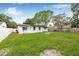 Expansive backyard with a pristine lawn, patio area, and a charming fire pit at 1349 Tyrone N Blvd, St Petersburg, FL 33710