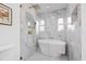 Luxurious bathroom with a soaking tub and marble-tiled walk-in shower with dual shower heads at 1349 Tyrone N Blvd, St Petersburg, FL 33710