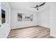 Bright bedroom featuring wood floors and a modern ceiling fan at 1349 Tyrone N Blvd, St Petersburg, FL 33710