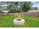 Inviting stone fire pit surrounded by green grass, perfect for outdoor gatherings at 1349 Tyrone N Blvd, St Petersburg, FL 33710