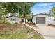 Inviting one-story home featuring a well-maintained lawn, attractive landscaping, and an attached single car garage at 1349 Tyrone N Blvd, St Petersburg, FL 33710