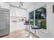 Eat-in kitchen features a cozy breakfast nook with backyard views, stainless steel appliances, and ample cabinet space at 1349 Tyrone N Blvd, St Petersburg, FL 33710