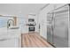 Well-lit kitchen with stainless steel appliances, granite countertops, an open layout and modern cabinetry at 1349 Tyrone N Blvd, St Petersburg, FL 33710