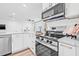 Modern kitchen with stainless steel appliances, including microwave and range at 1349 Tyrone N Blvd, St Petersburg, FL 33710