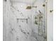 Elegant walk-in shower showcasing beautiful marble tiling and gold hardware at 1349 Tyrone N Blvd, St Petersburg, FL 33710