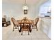 Comfortable dining area with wood furniture, pendant lighting, and a pass-through to the kitchen at 13926 Mission Oaks Blvd, Seminole, FL 33776