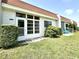 Inviting home exterior featuring a well-maintained lawn and lush landscaping at 13926 Mission Oaks Blvd, Seminole, FL 33776