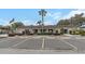 Well-maintained exterior of building, ample parking, and beautiful landscaping at 13926 Mission Oaks Blvd, Seminole, FL 33776