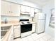 Cozy kitchen with essential appliances, ample cabinet space, and a bright, clean atmosphere at 13926 Mission Oaks Blvd, Seminole, FL 33776