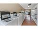 Bright laundry room featuring multiple modern washing machines, creating a practical and efficient space at 13926 Mission Oaks Blvd, Seminole, FL 33776