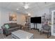 Cozy living area featuring a comfortable sofa, TV, and bookshelves, perfect for relaxing and entertainment at 13926 Mission Oaks Blvd, Seminole, FL 33776