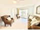 A comfortable living room with plenty of natural light and a cozy seating arrangement with tile flooring at 13926 Mission Oaks Blvd, Seminole, FL 33776