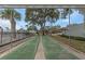 Well-maintained shuffleboard courts surrounded by lush greenery and trees at 13926 Mission Oaks Blvd, Seminole, FL 33776
