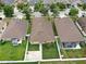 Aerial view of a property showcasing the roof, backyard, and surrounding neighborhood at 14224 Edinburgh Moor Dr, Wimauma, FL 33598