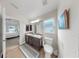 Bright bathroom with a double sink vanity, tile floors, a window, and access to the bedroom at 14224 Edinburgh Moor Dr, Wimauma, FL 33598