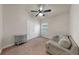 Cozy bedroom with carpet, ceiling fan, and double door closet near a window bringing in natural light at 14224 Edinburgh Moor Dr, Wimauma, FL 33598