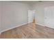 Empty room featuring wood flooring, neutral walls, white trim, and a closet for storage at 14224 Edinburgh Moor Dr, Wimauma, FL 33598
