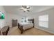 This bedroom features a ceiling fan, light walls, new carpet, a dresser, and a flat screen TV at 14224 Edinburgh Moor Dr, Wimauma, FL 33598