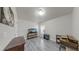 Simple secondary bedroom with light walls, wood floors, and built-in shelving for storage or decor at 14224 Edinburgh Moor Dr, Wimauma, FL 33598