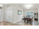 Bright dining room with hardwood floors and neutral walls, complemented by a modern light fixture at 14224 Edinburgh Moor Dr, Wimauma, FL 33598