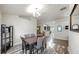 Bright dining room with hardwood floors and neutral walls, complemented by a modern light fixture at 14224 Edinburgh Moor Dr, Wimauma, FL 33598