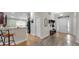 Inviting foyer showcasing wood and tile flooring, storage, and a view into the kitchen at 14224 Edinburgh Moor Dr, Wimauma, FL 33598
