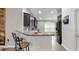 Charming kitchen with bar seating, dark wood cabinets, and stainless steel appliances at 14224 Edinburgh Moor Dr, Wimauma, FL 33598