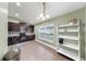This kitchen features dark wood cabinets, recessed lighting, tiled floor, and a white display shelf at 14224 Edinburgh Moor Dr, Wimauma, FL 33598
