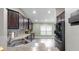 This kitchen features dark wood cabinets, stainless steel appliances, double sink, and granite counters at 14224 Edinburgh Moor Dr, Wimauma, FL 33598
