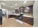 Well-equipped kitchen with dark cabinets, stone countertops, and stainless steel appliances at 14224 Edinburgh Moor Dr, Wimauma, FL 33598