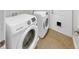 Functional laundry room with a modern washer and dryer set and access to the backyard at 14224 Edinburgh Moor Dr, Wimauma, FL 33598