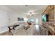 Comfortable living room with a plush sofa, accent chair, and a rustic wood accent wall with a mounted TV at 14224 Edinburgh Moor Dr, Wimauma, FL 33598