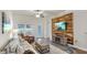 Inviting living room featuring a cozy sofa, accent chair, and a striking wood-paneled accent wall with a TV at 14224 Edinburgh Moor Dr, Wimauma, FL 33598