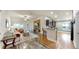 Open-concept living area with modern stone accent wall and seamless flow to kitchen at 14224 Edinburgh Moor Dr, Wimauma, FL 33598