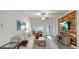 Bright living room featuring stylish furniture, wood-look floors and unique accent wall at 14224 Edinburgh Moor Dr, Wimauma, FL 33598